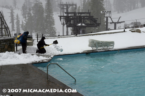 Nugget #112 C shoveling snow into lagoon Nugget #112 C shoveling snow into lagoon